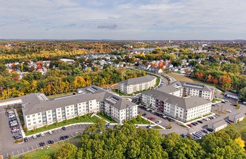 An aerial view of a hotel surrounded by trees in autumn.