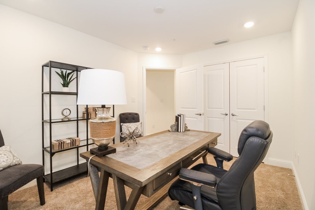 a dining room with a wooden table and black chairs