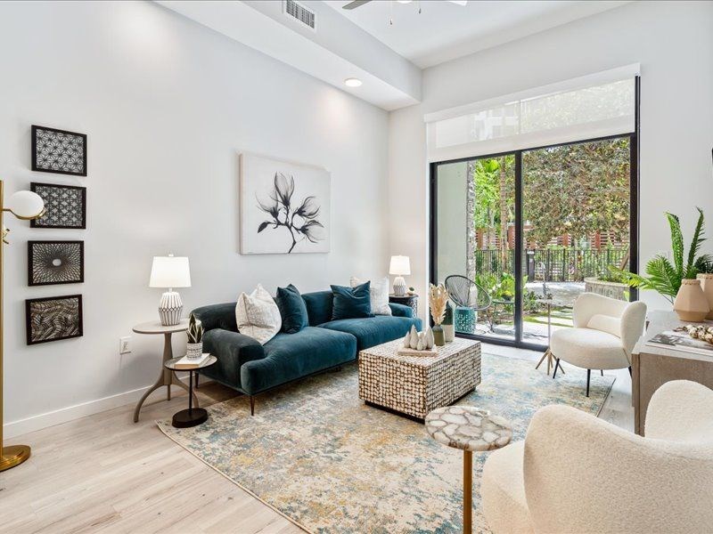 a living room with white walls and a sliding glass door