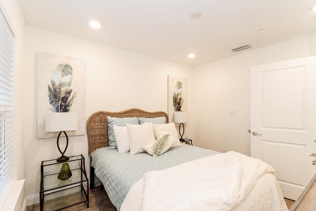 a bedroom with a bed and a window