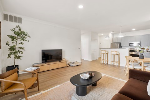 A living room with a brown chair and a black coffee table.