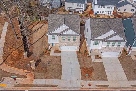 an aerial view of a neighborhood with houses and a street