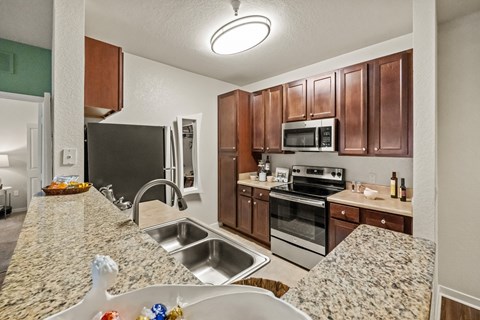 a kitchen with granite counter tops and stainless steel appliances