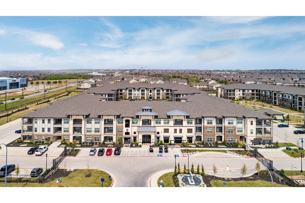 an aerial view of a large building with a parking lot