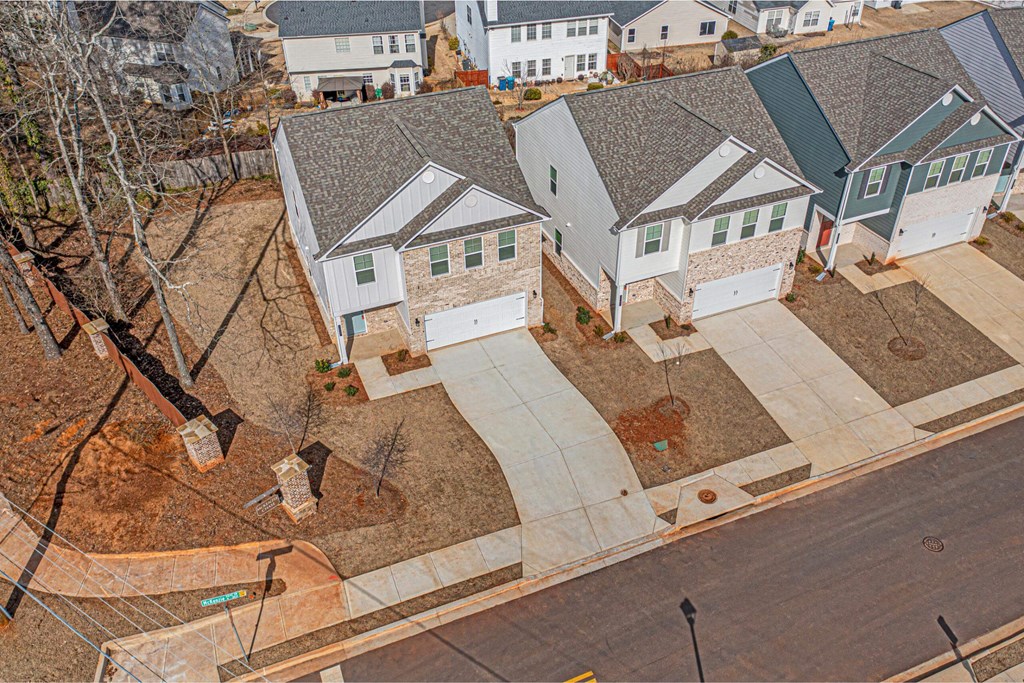 an aerial view of a neighborhood with houses and a street