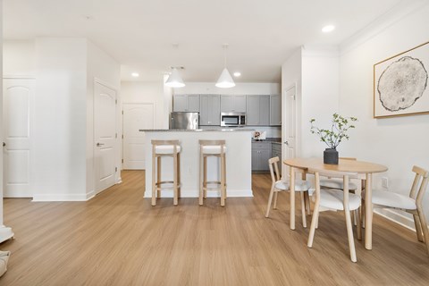 A kitchen with a table and chairs in the middle of the room.
