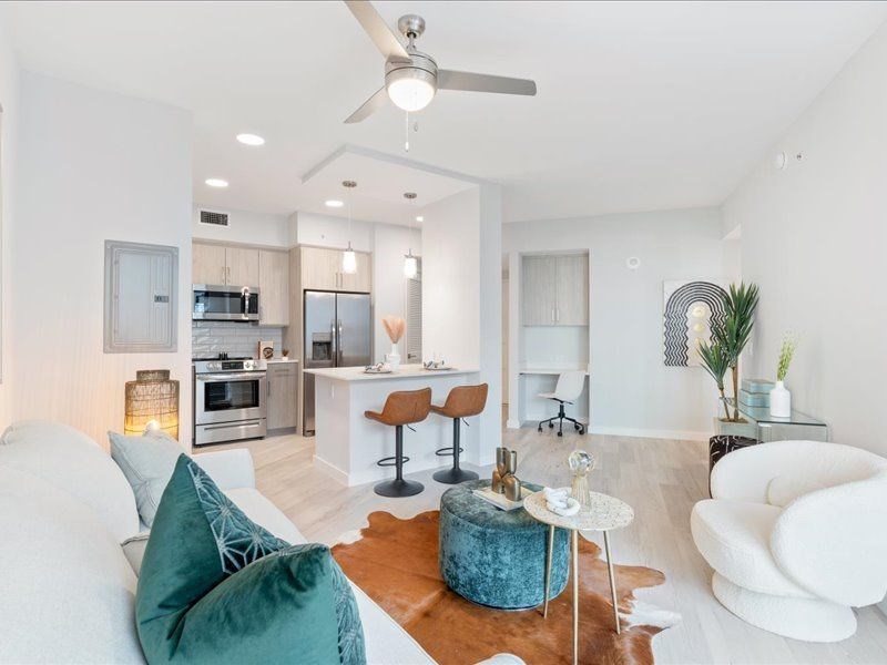 a living room and kitchen with a couch and a table