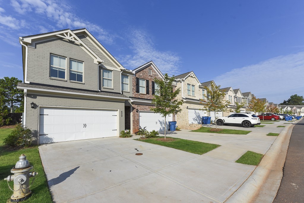 a row of houses on a street with a fire hydrant