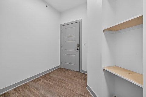Apartment entry with  built-in shelving