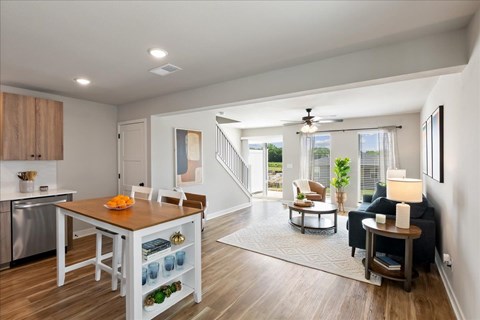 A modern kitchen with a dining table and chairs.