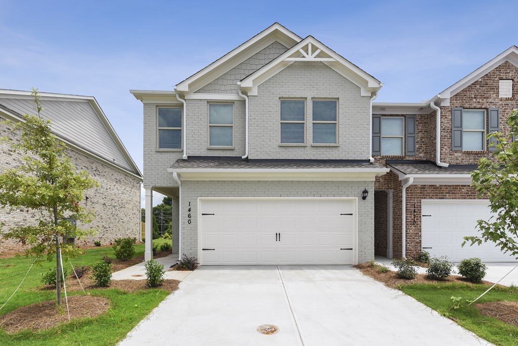 a house with a white garage door in front of it