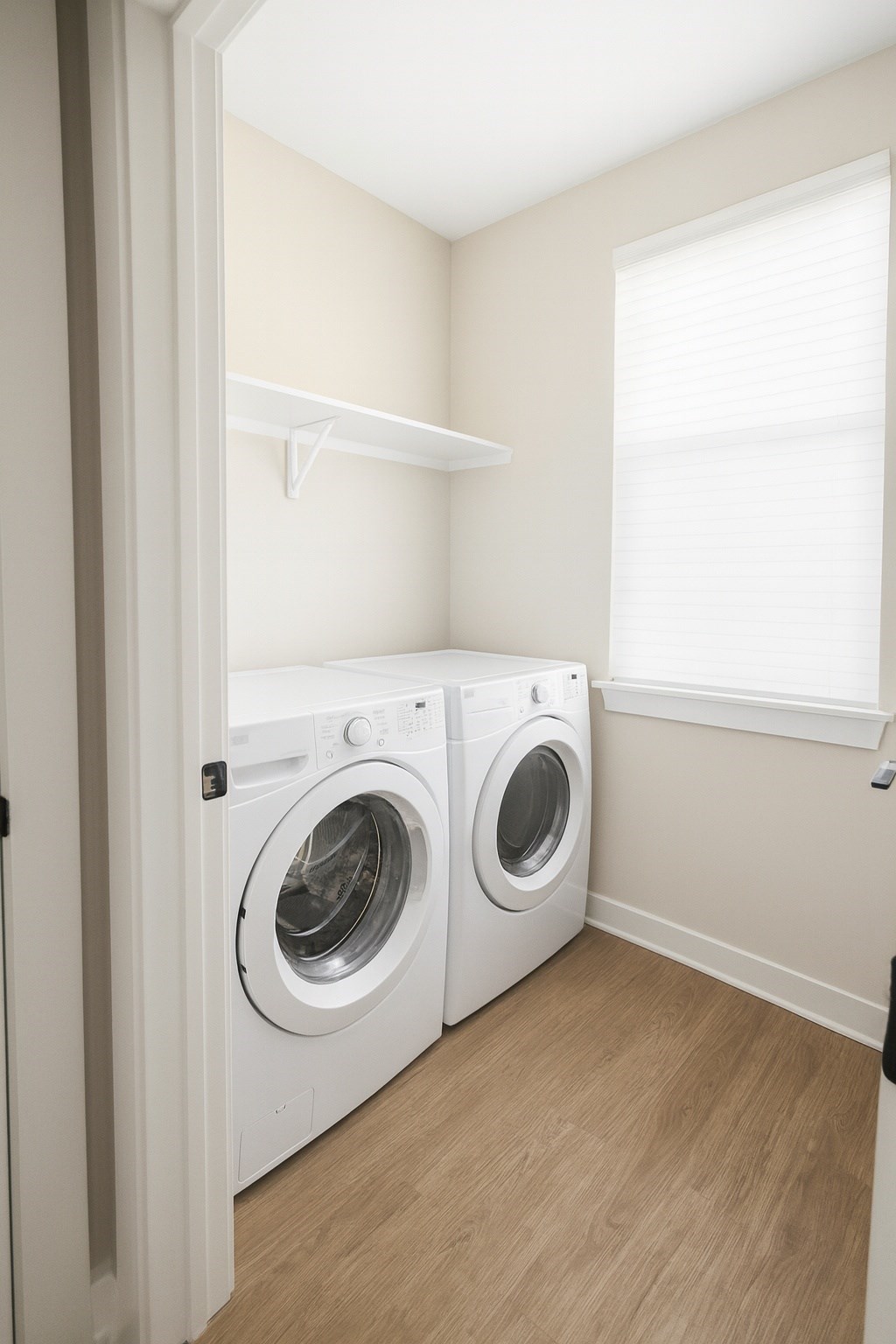 A white washing machine and dryer in a small laundry room.