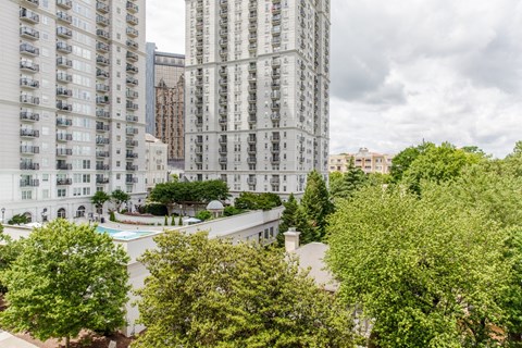 an aerial view of a city with tall buildings and trees