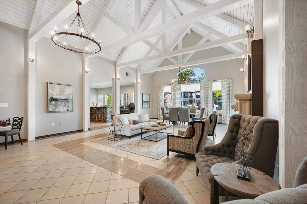 a large living room with couches and chairs