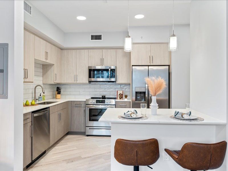 a kitchen with wooden cabinets and a white counter top