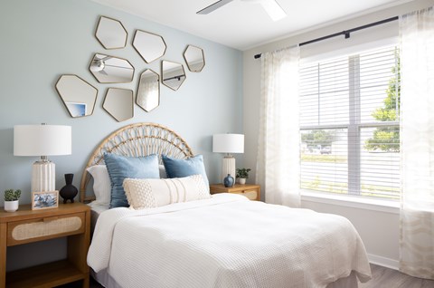 a bedroom with a bed and a window