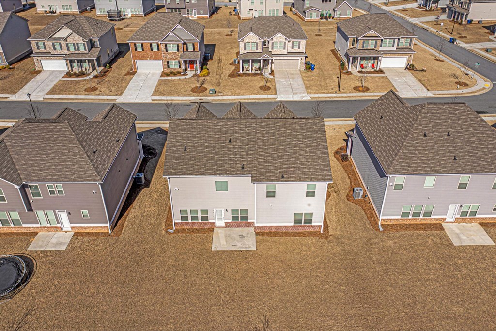 a group of houses sitting on top of a field