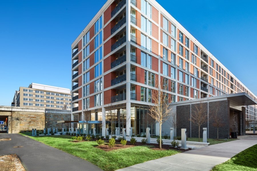 a large building with a sidewalk in front of it