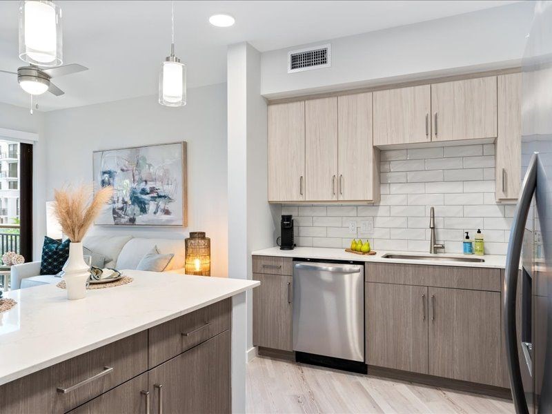 a kitchen with wooden cabinets and stainless steel appliances