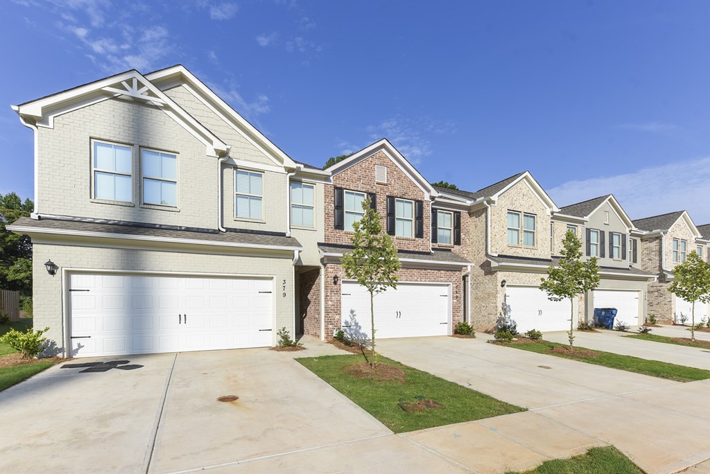 a house with two garage doors in front of it