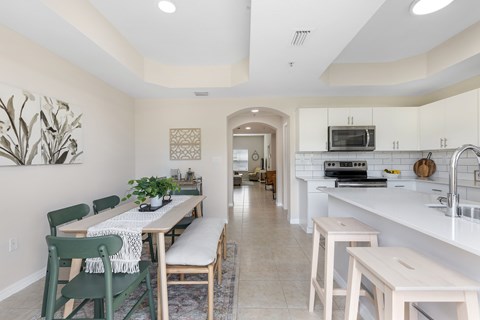 an open kitchen and dining room with a table and chairs