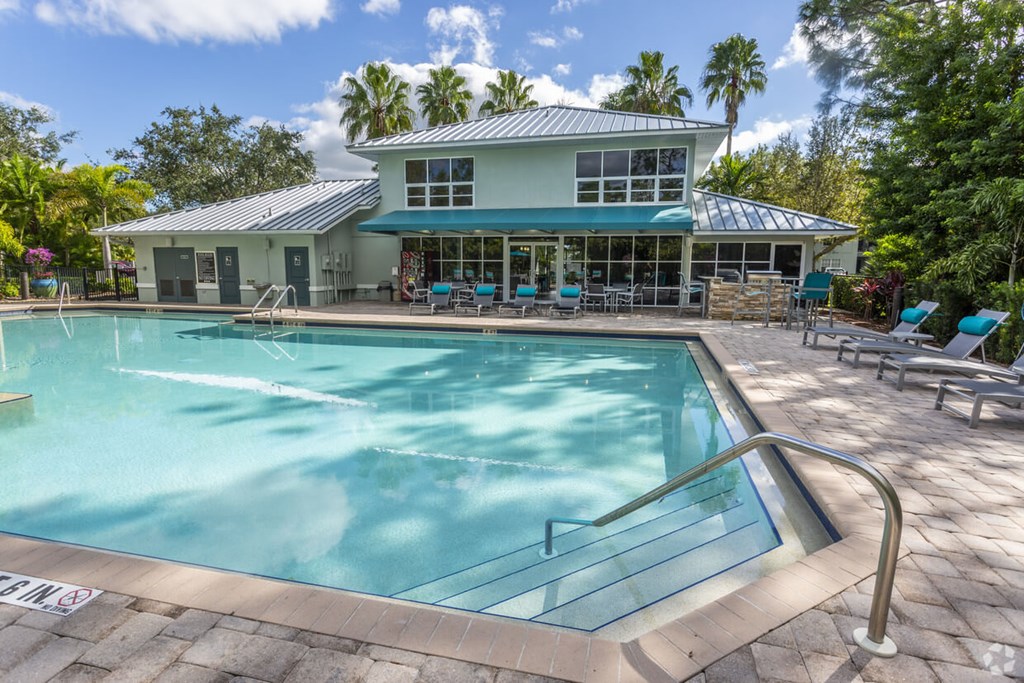 a swimming pool with a house in the background