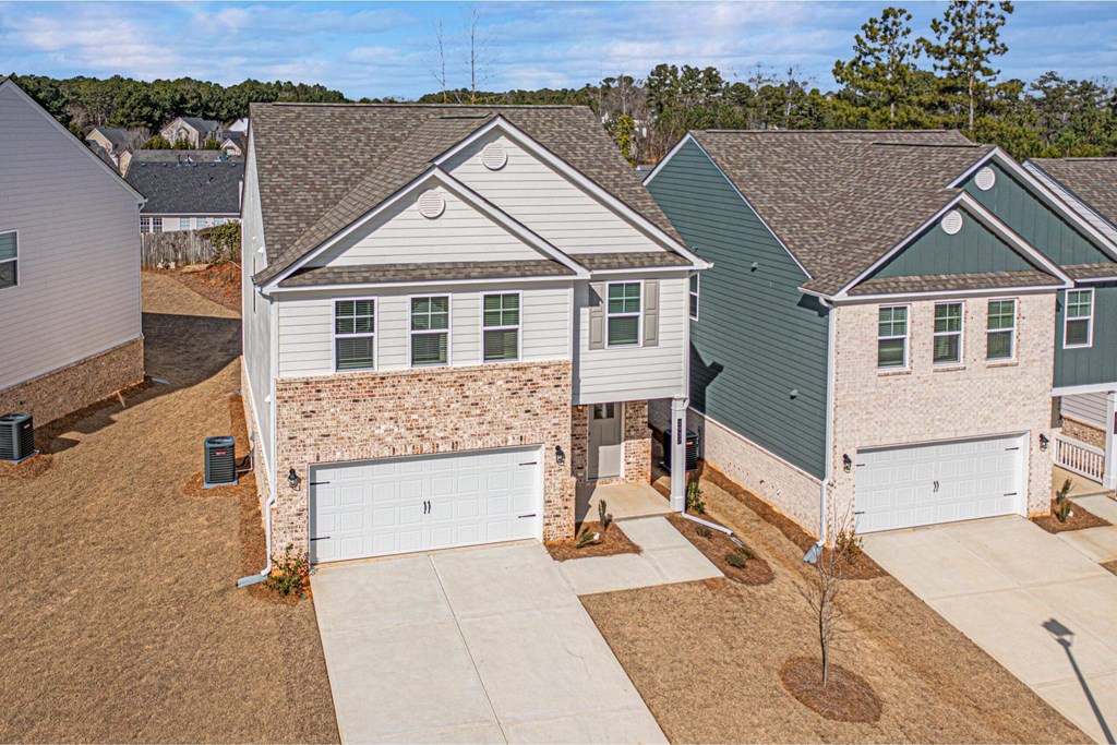 an aerial view of a house with a white garage door