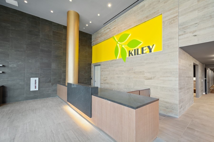 the lobby of a store with a yellow logo on the wall