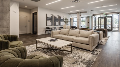 A modern living room with a large sectional sofa and a coffee table.