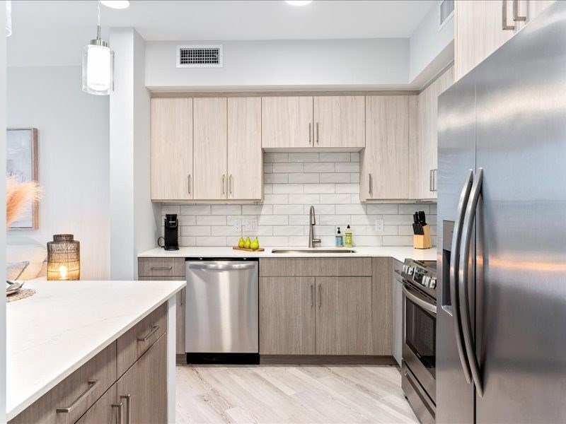 a lobby with a glass table and a wall with geometric patterns