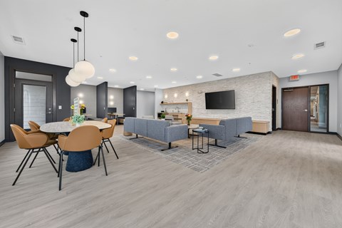 A modern dining room with a large table and chairs.