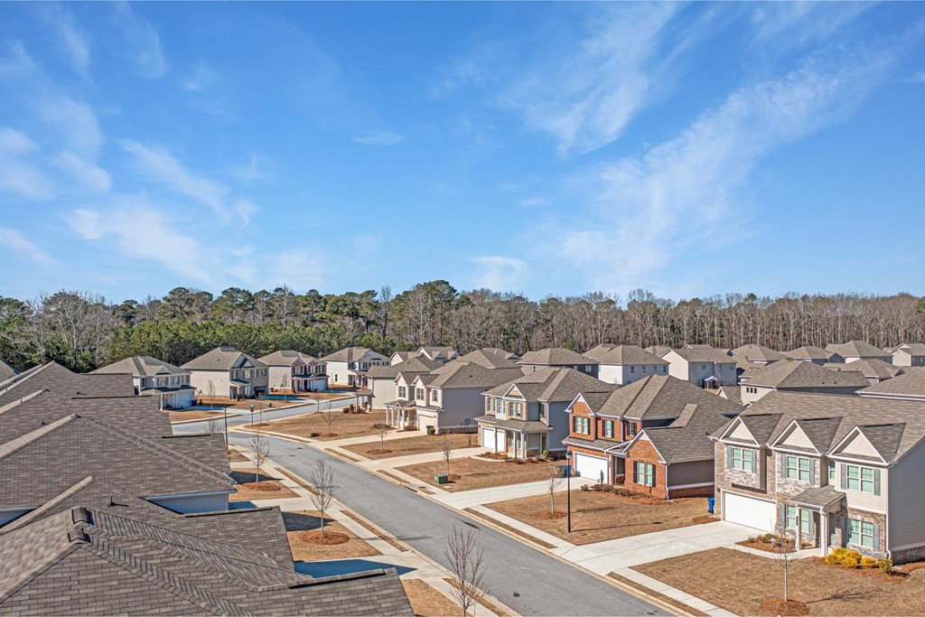 an aerial view of a neighborhood with rows of houses