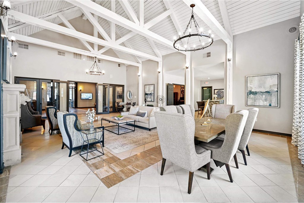 a large living room with a dining room table and chairs