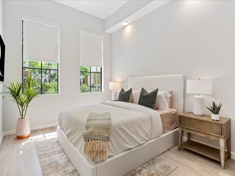 a bedroom with a bed next to a window