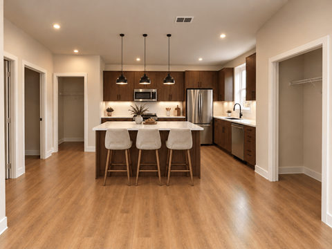 A modern kitchen with wooden floors and a central island.