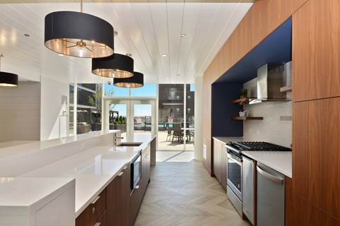 A modern kitchen with a long counter and a large island.
