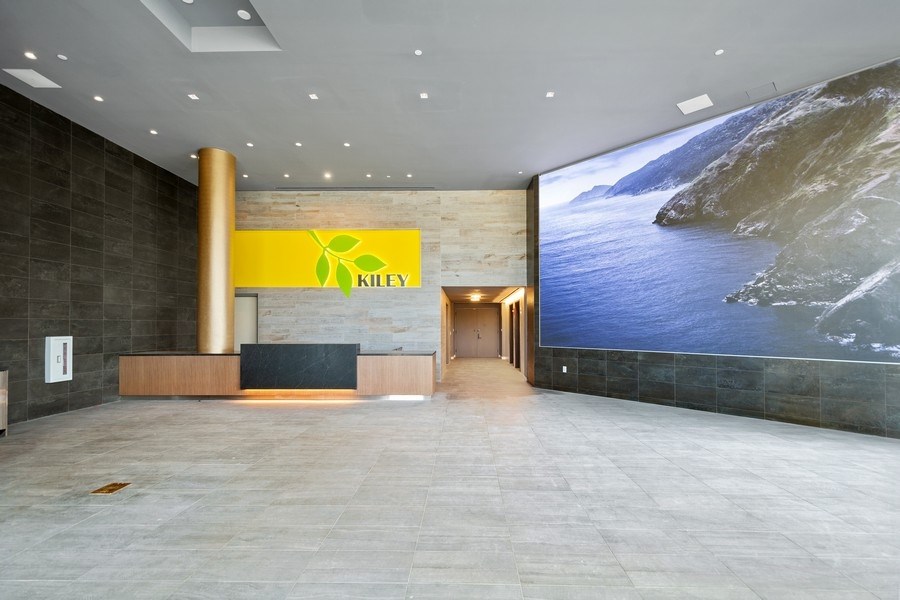 the lobby of a building with a large picture of the ocean on the wall
