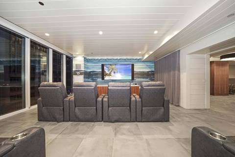 A modern living room with grey sofas and a television.