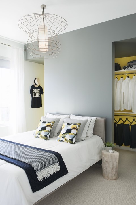 a bedroom with a bed with pillows and a closet