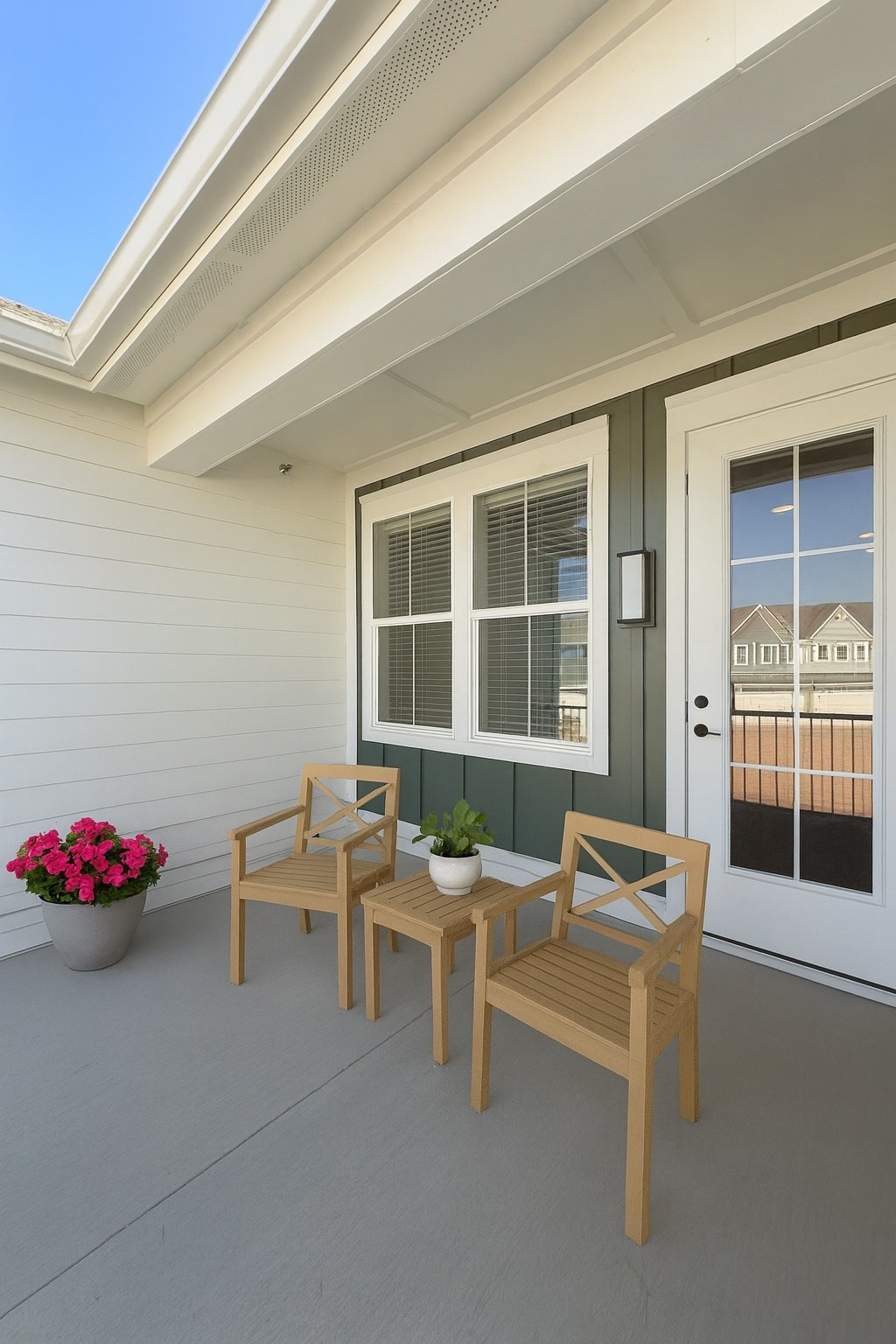 A patio with a table and two chairs.