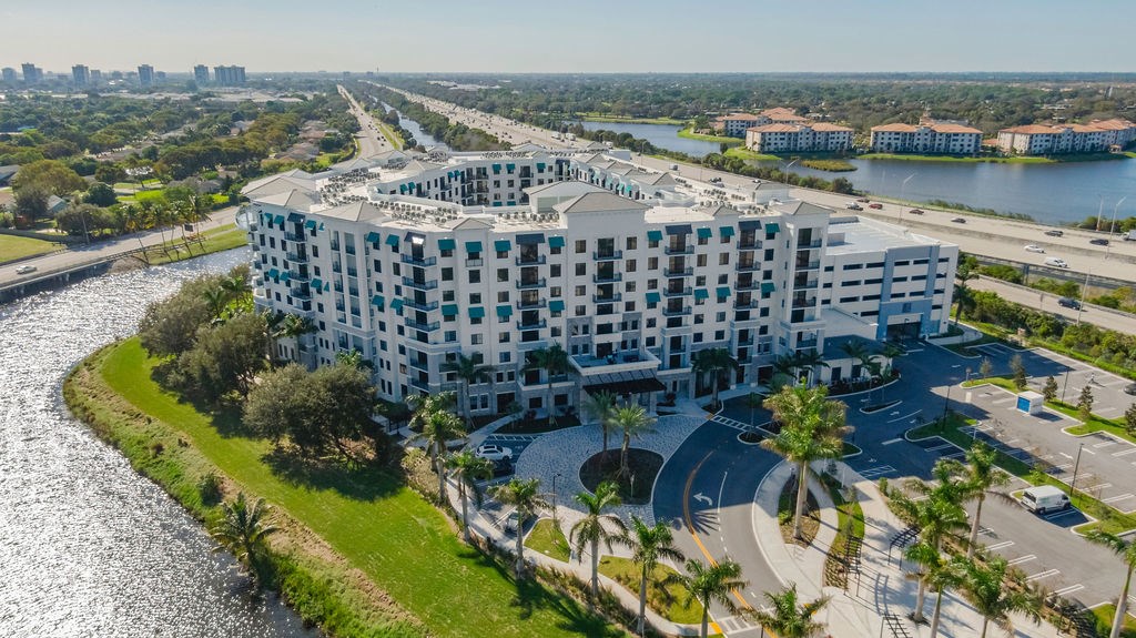 an aerial view of a building next to a body of water