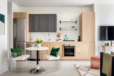 A modern kitchen with a table and chairs.