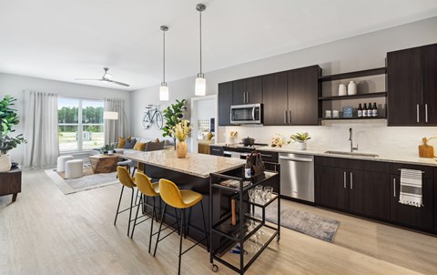 A modern kitchen with a dining table and chairs.