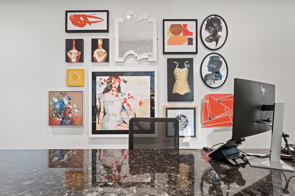 A modern art gallery with a laptop on a table.