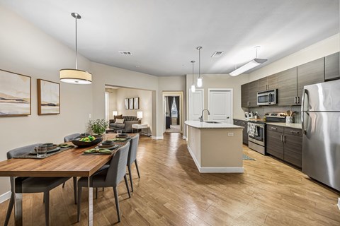 A modern kitchen with a dining table and chairs.