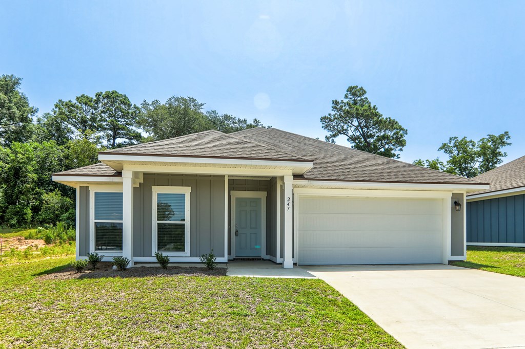 the front of a house with a driveway and a garage door