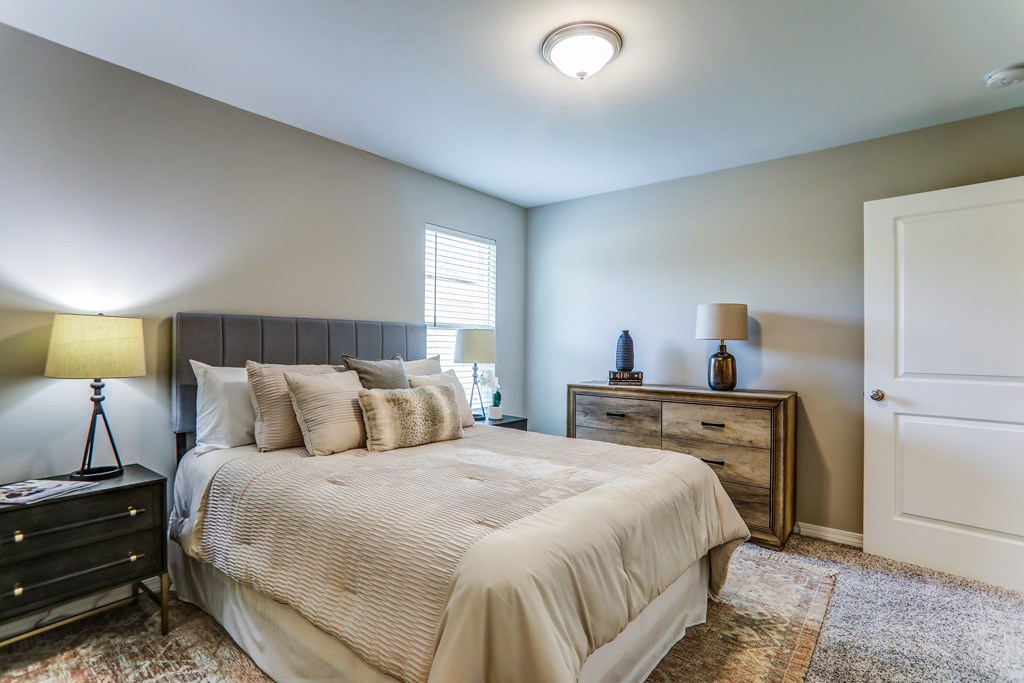 a bedroom with a large bed and a window