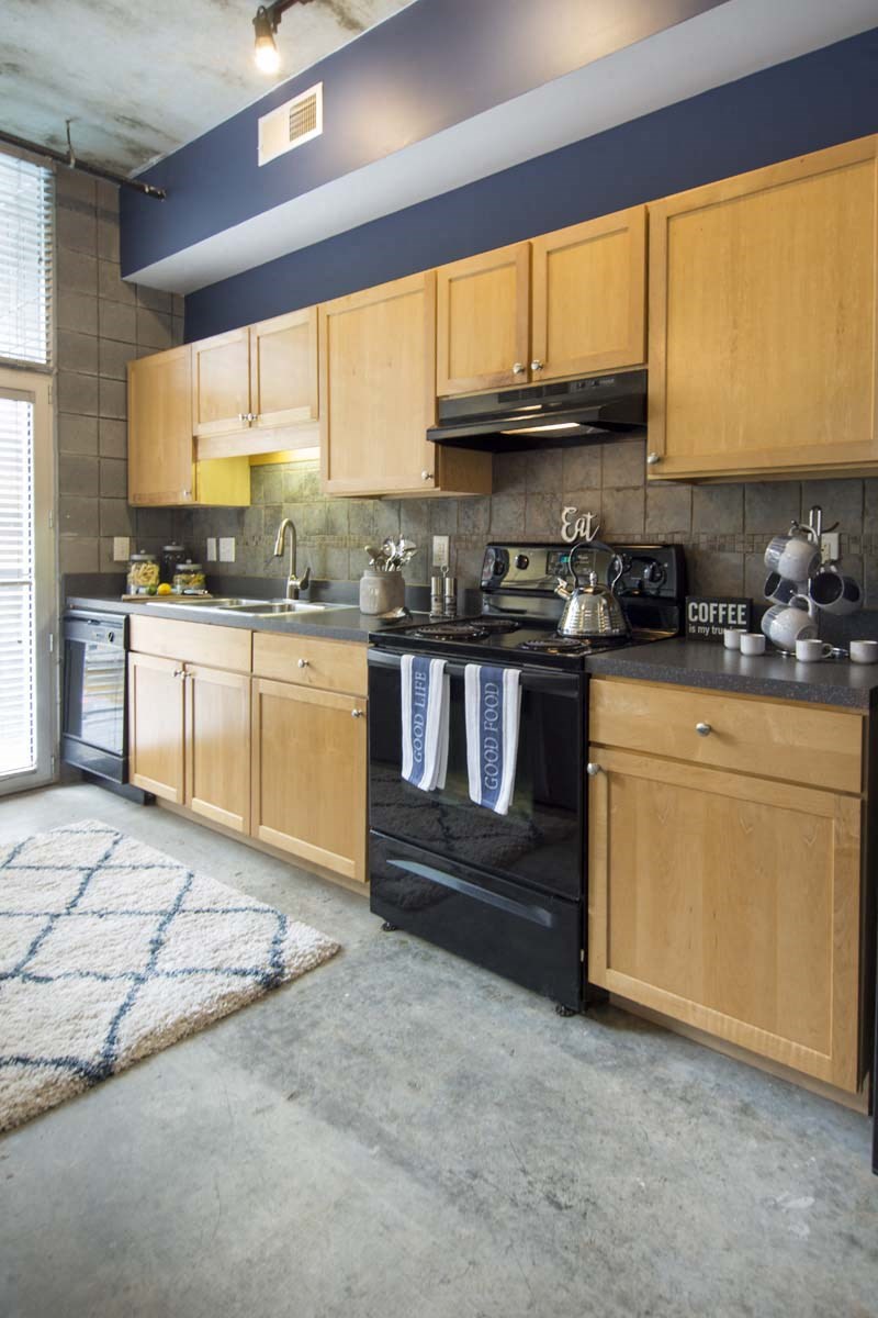 a kitchen with wooden cabinets and black appliances