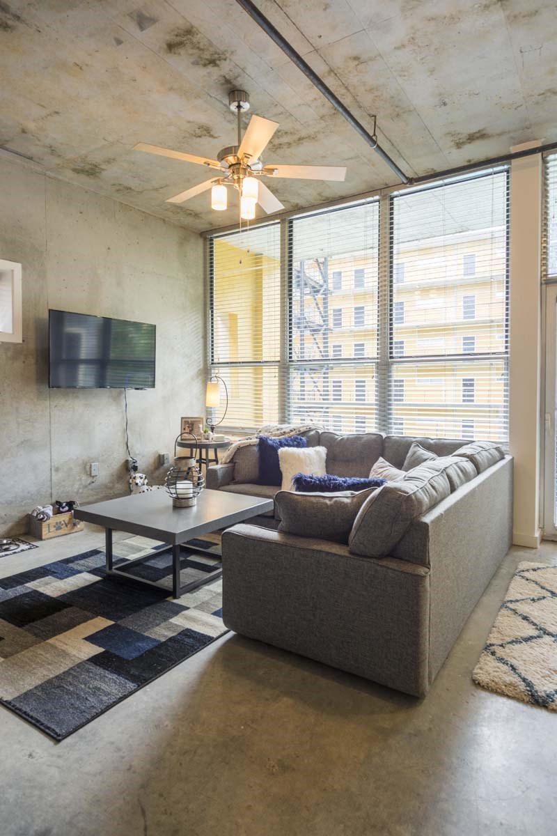 a living room filled with furniture and a flat screen tv