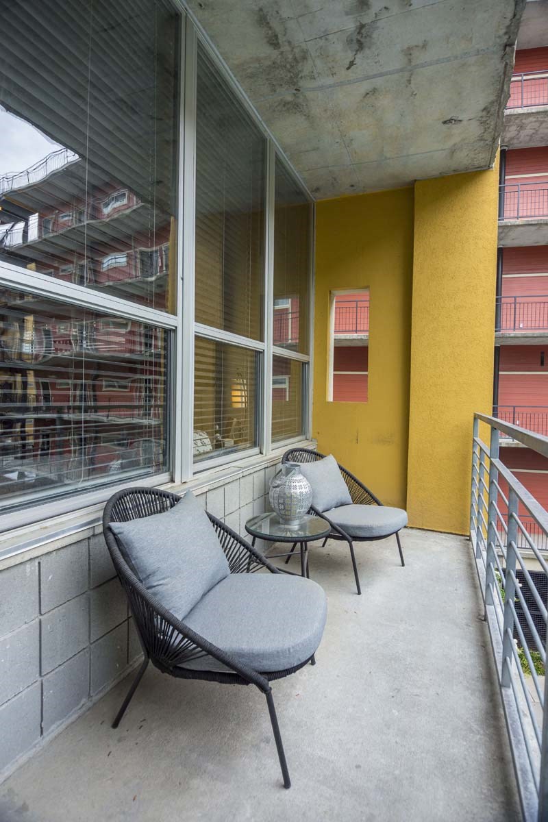 a balcony with two chairs and a table